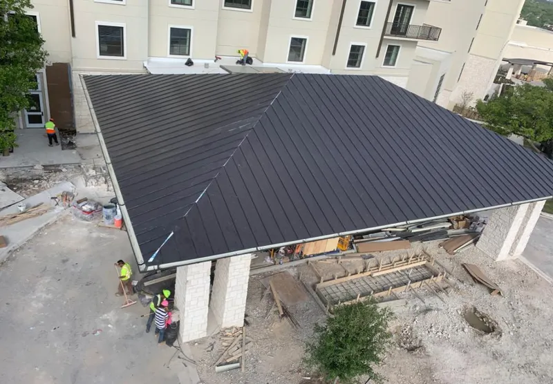Metal roofing installation team working on a commercial building in McGregor